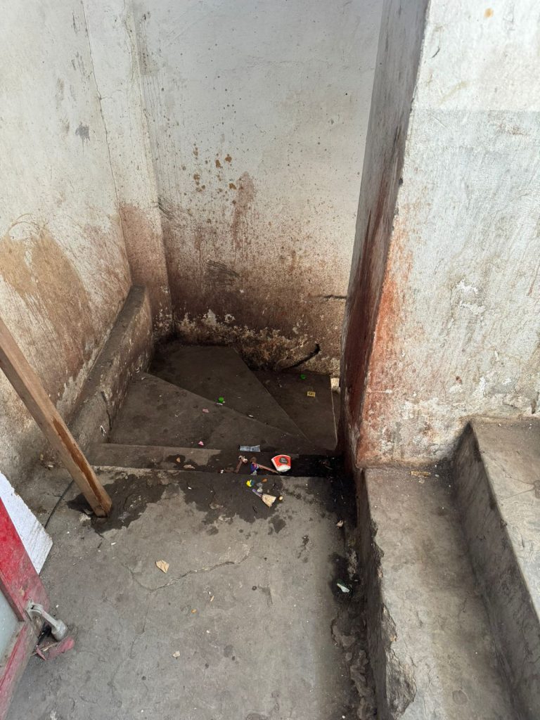 Grimy, broken service stair with litter